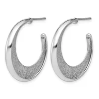 A pair of silver hoop earrings with a polished outer surface and textured inner surface, displayed against a white background.