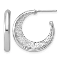 A pair of silver hoop earrings, one with a smooth polished finish and one with a textured sparkly surface, displayed against a white background.