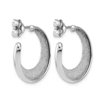 A pair of silver hoop earrings with textured surfaces on the outer edges and polished smooth inner curves, shown from the front against a white background.