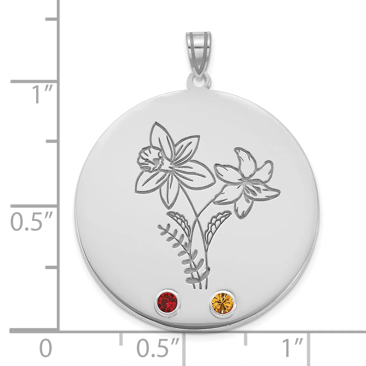 Silver circular pendant with engraved flowers and leaves, decorated with a red gemstone and a yellow gemstone at the bottom, shown next to a ruler for scale.
