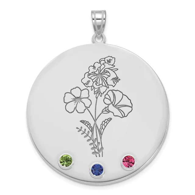 Silver circular pendant with engraved flowering plant design and three round gemstones in green, blue, and pink set along the bottom edge, suspended from a silver bail.
