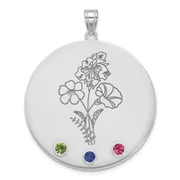 Silver circular pendant with engraved flowering plant design and three round gemstones in green, blue, and pink set along the bottom edge, suspended from a silver bail.