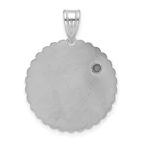 Silver pendant with a scalloped circular disc and a small dark stone set on the side, suspended from a bail loop.