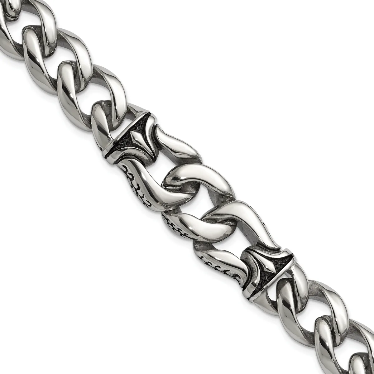 A silver curb chain bracelet with decorative ornamental links featuring scrollwork details and small stamped hallmarks, displayed diagonally against a white background.
