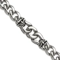 A silver curb chain bracelet with decorative ornamental links featuring scrollwork details and small stamped hallmarks, displayed diagonally against a white background.