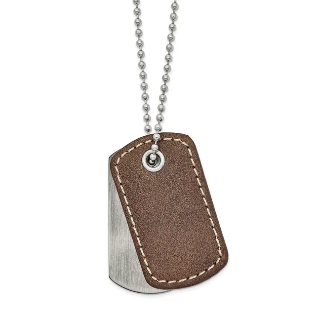 A stainless steel dog tag with brown leather backing and contrasting stitching hangs from a beaded chain.