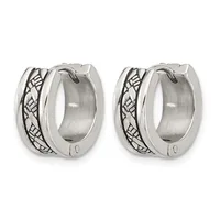 A pair of polished silver huggie hoop earrings with an oxidized geometric leaf or wing pattern along the sides, shown from the front against a white background.