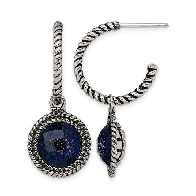 Pair of silver-toned twisted hoop earrings with round lapis lazuli stone pendants set in ornate twisted frames.