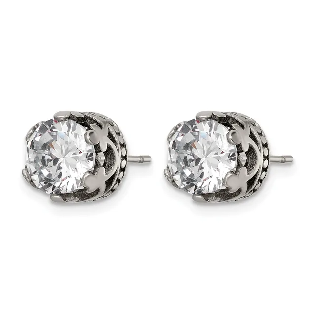 A pair of silver stud earrings with round clear cubic zirconia stones set in ornate filigree settings with small posts.