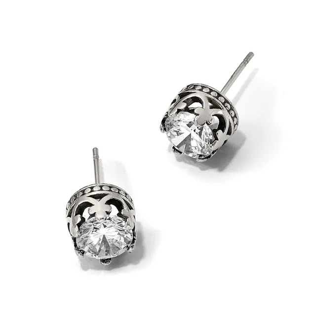 A pair of silver stud earrings with ornate filigree settings holding round brilliant-cut clear gemstones, displayed against a white background.