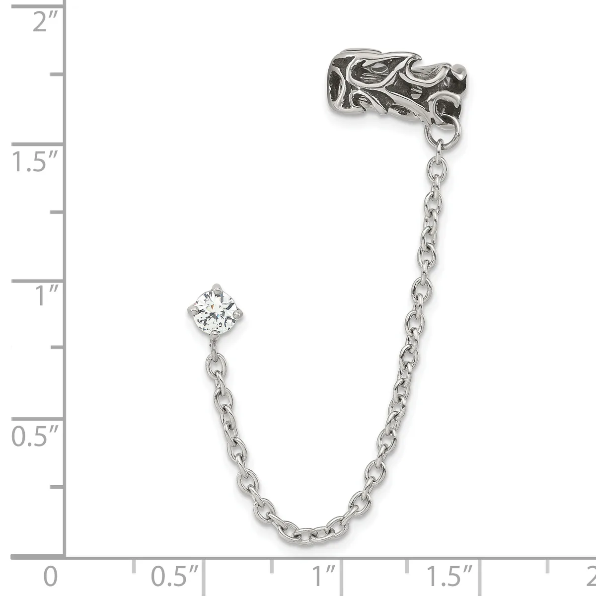 Silver chain bracelet with an ornate leaf-patterned connector at one end and a small cubic zirconia charm dangling from the middle, displayed against a measurement scale.