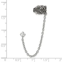 Silver-tone ornate brooch with dangling chain and clear crystal stone, shown against a ruler measuring approximately two inches in length.