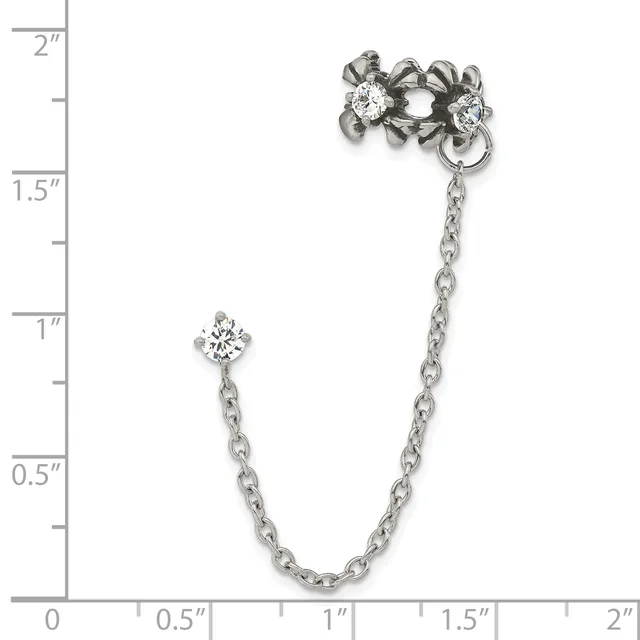 Silver-tone chain brooch with a single diamond accent on one end and an ornate flower cluster with multiple diamonds on the other end, displayed against a measurement scale.