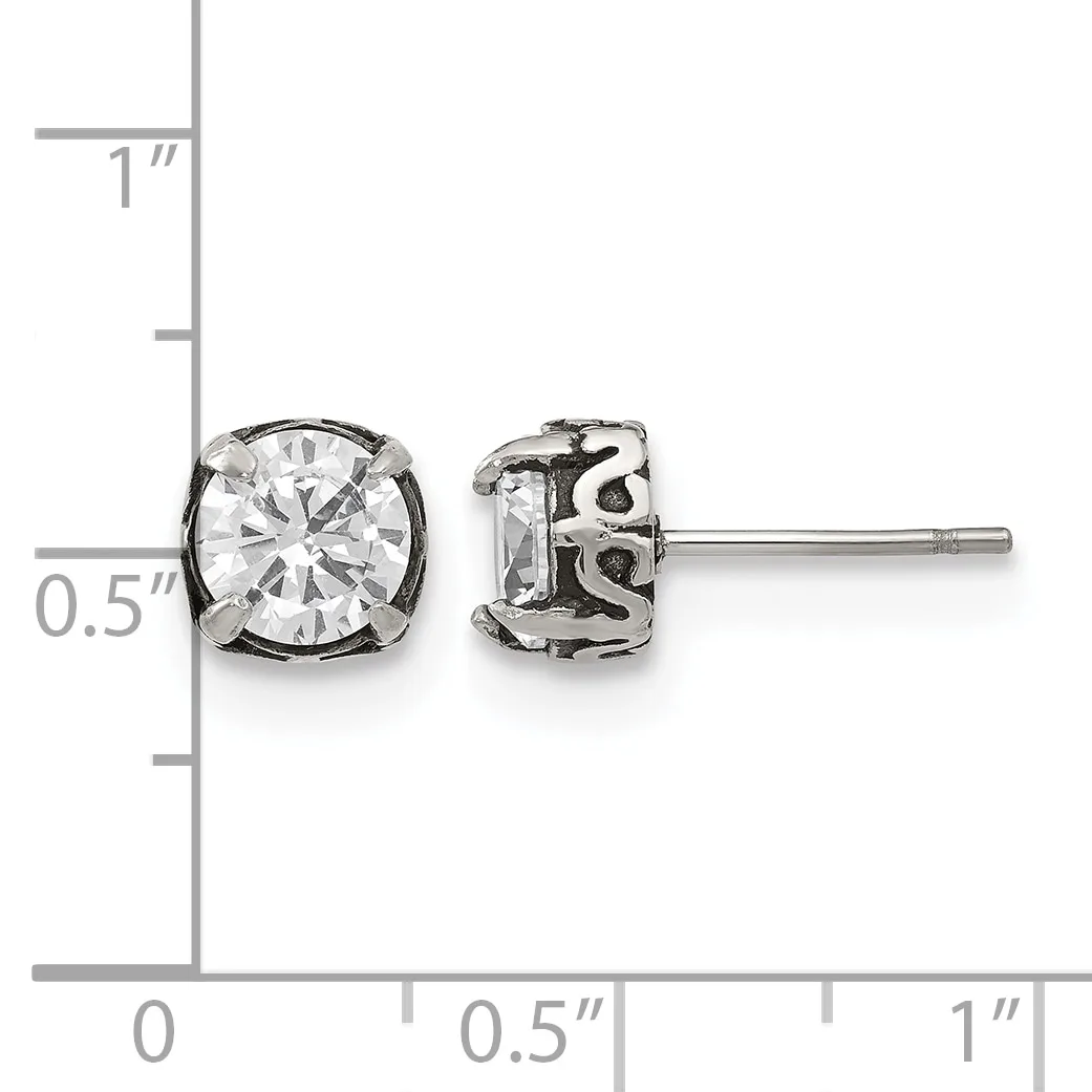 Pair of silver stud earrings with round clear cubic zirconia stones in decorative settings, displayed against a measurement ruler.