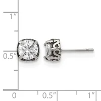Pair of silver stud earrings with round clear cubic zirconia stones in decorative settings, displayed against a measurement ruler.