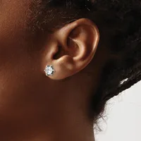 A person wearing a diamond stud earring in their earlobe, shown in profile against a neutral background.