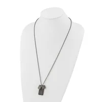 A long silver-toned chain necklace with a rectangular pendant and small geometric charms displayed on a white bust form.