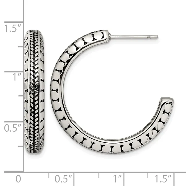 A pair of silver hoop earrings with decorative beaded and textured patterns, displayed next to a measurement ruler showing they are approximately 1.5 inches long.