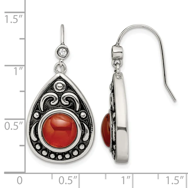 Pair of teardrop-shaped silver earrings with ornate scrollwork frames featuring round red cabochon stones, shown front and back with a measurement scale.