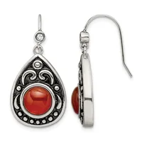 Pair of silver teardrop earrings with ornate scrollwork frames holding red cabochon stones, suspended from round crystal studs, shown from front and back views.