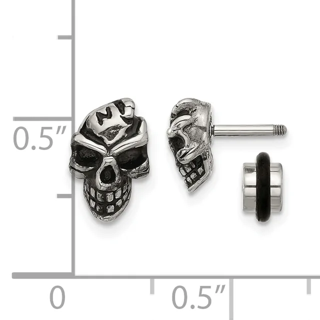 Pair of silver skull stud earrings with detailed facial features shown front and side view against a measurement scale.
