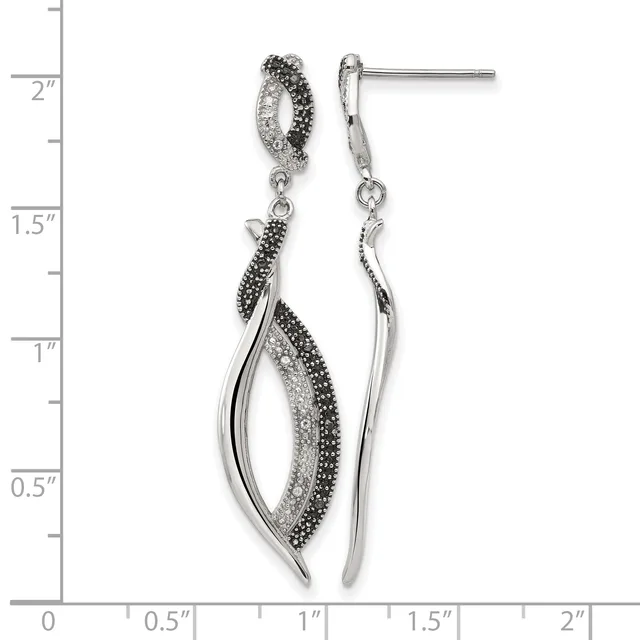 Pair of silver drop earrings with black and clear crystals arranged in curved leaf shapes, shown against a measurement scale.