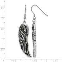 A pair of silver-toned dangle earrings featuring detailed wing-shaped pendants with feather texturing, displayed against a measurement scale.