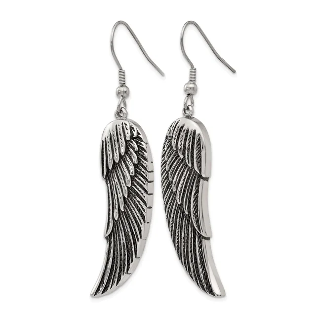 A pair of silver-toned dangling earrings with detailed wing designs, suspended from fish hook-style ear wires.