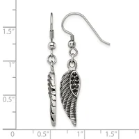 A pair of silver-toned dangle earrings featuring textured wing charms suspended from fish hook wires, displayed against a measurement scale showing approximately 1.5 inches in length.