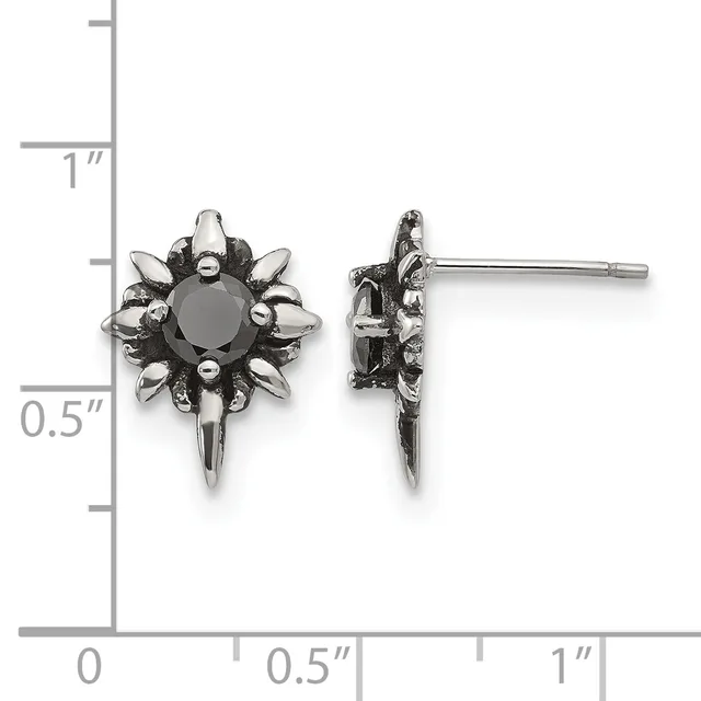 Pair of ornate silver-toned stud earrings with dark round stones surrounded by decorative spikes, displayed against a measurement ruler showing approximately 0.5 inches in height.