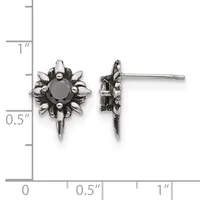 Pair of ornate silver-toned stud earrings with dark round stones surrounded by decorative spikes, displayed against a measurement ruler showing approximately 0.5 inches in height.