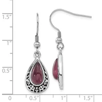 Two silver teardrop earrings with ornate filigree frames containing dark red cabochon stones, shown against a measurement scale indicating approximately one inch in length.