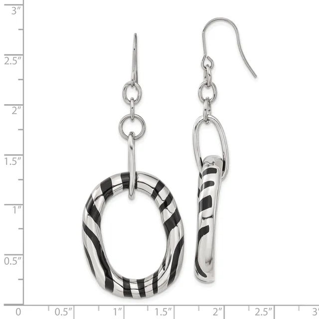 A pair of silver dangle earrings with black and white striped resin components, displayed against a measurement scale showing they are approximately three inches long.