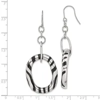 A pair of silver dangle earrings with black and white striped resin components, displayed against a measurement scale showing they are approximately three inches long.