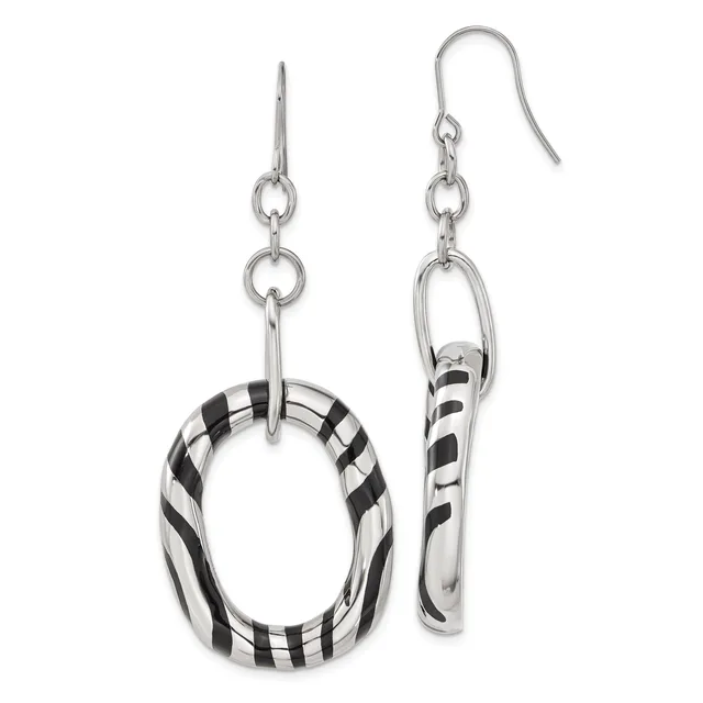 A pair of silver dangle earrings with black and white striped resin rings, one oval-shaped and one curved tube-shaped, suspended from silver hooks.
