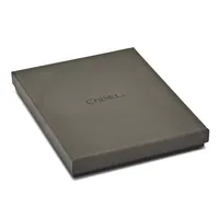 A gray rectangular box with a flat lid sits at a slight angle against a white background.