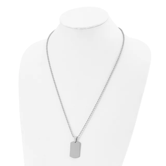 A silver-toned chain necklace with an attached rectangular dog tag pendant displayed on a white bust form.