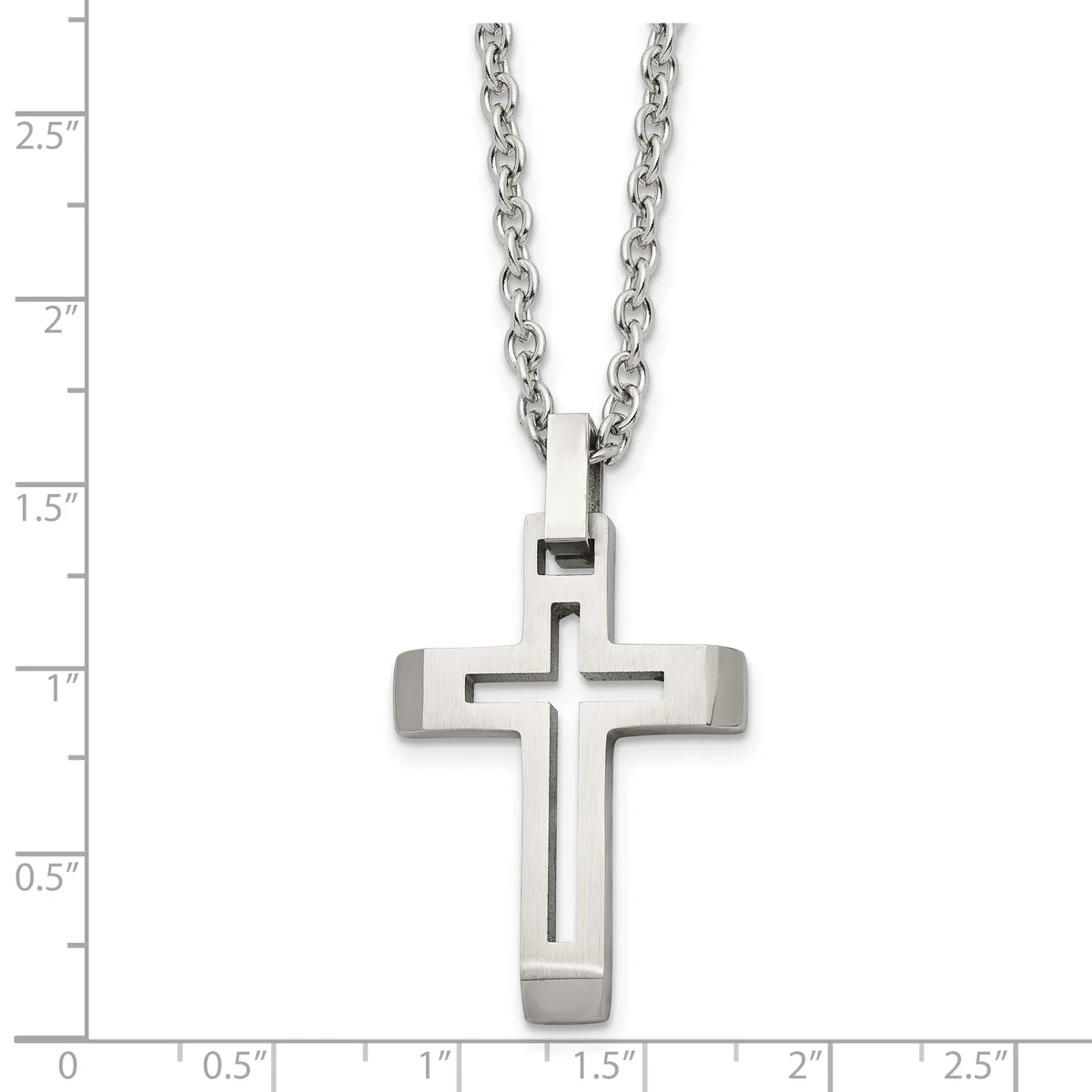 A stainless steel cross pendant with a cutout cross design hanging from a cable chain, shown against a measurement scale.