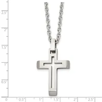 A stainless steel cross pendant with a cutout cross design hanging from a cable chain, shown against a measurement scale.