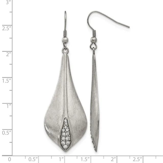 A pair of silver teardrop earrings with textured finish and crystal accents, shown front and side view against a measurement scale.
