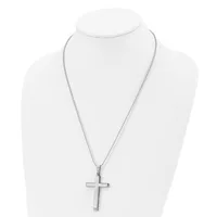 A silver-toned cross pendant hangs from a delicate chain on a white display bust form.