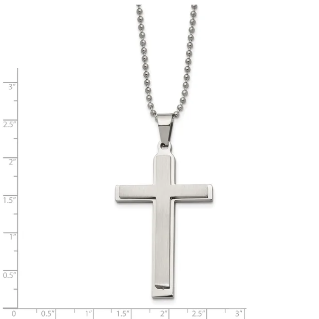 A polished silver cross pendant hangs from a beaded silver chain, displayed against a measurement scale showing the pendant is approximately 1.5 inches tall.