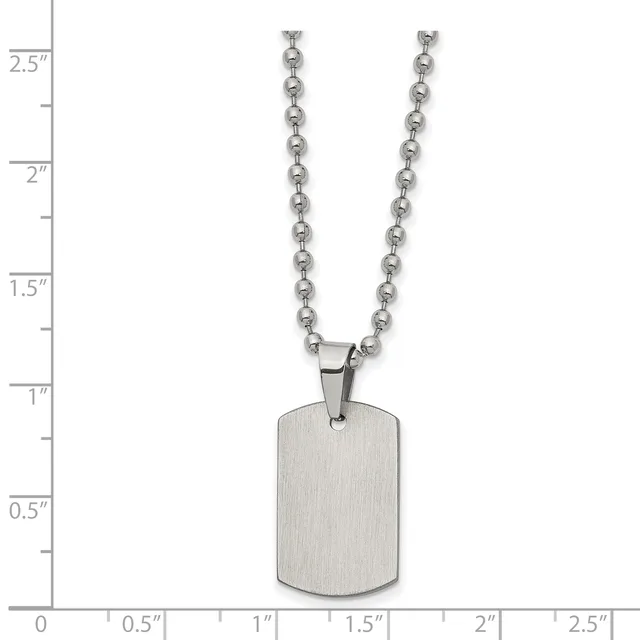 A brushed stainless steel dog tag pendant hangs from a ball chain necklace, displayed against a measurement scale showing approximately 2.5 inches in length.