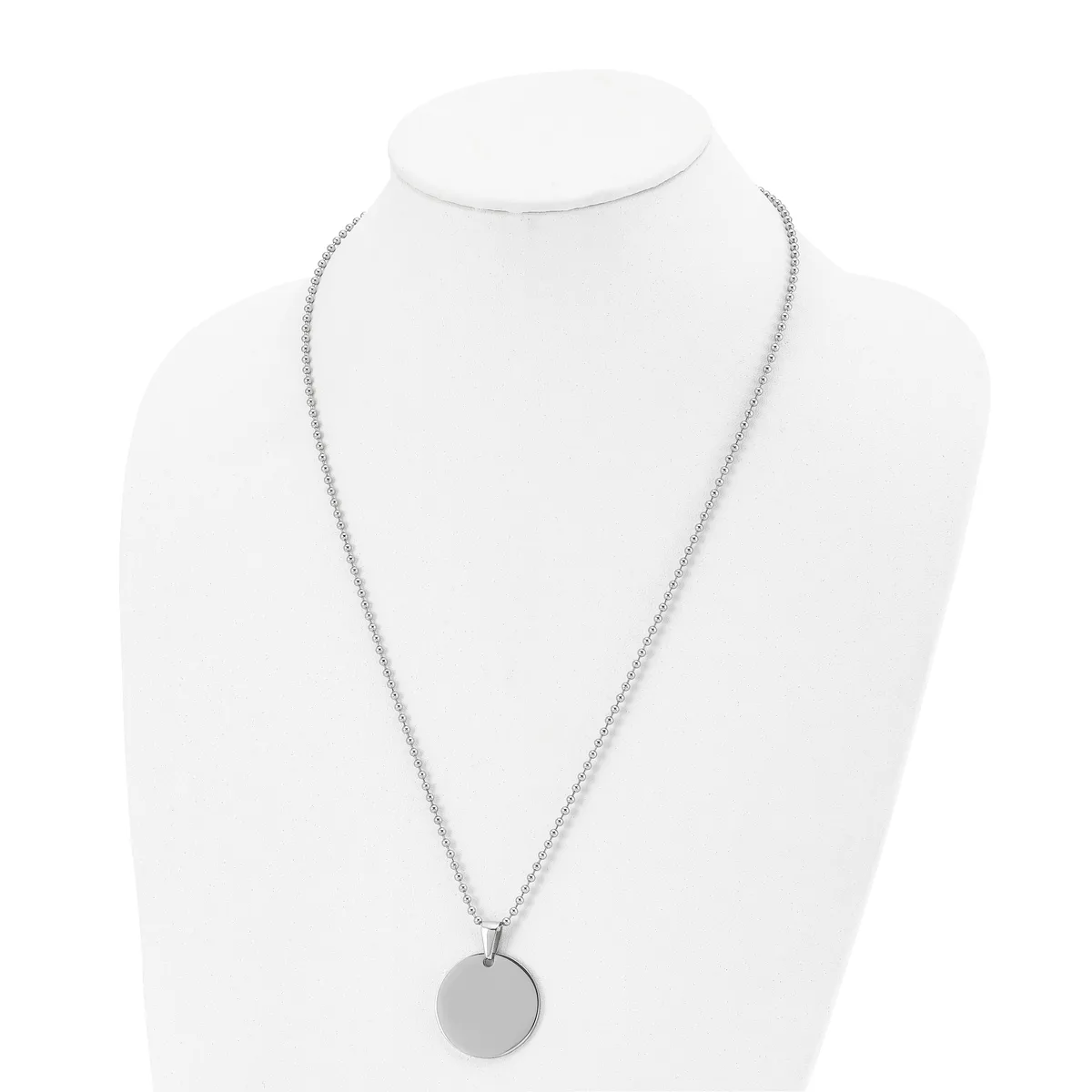 A silver-tone chain necklace with a round disc pendant displayed on a white mannequin bust.