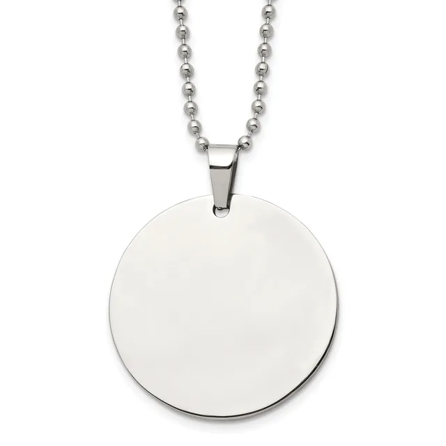 A polished stainless steel circular pendant hangs from a matching ball chain necklace against a white background.