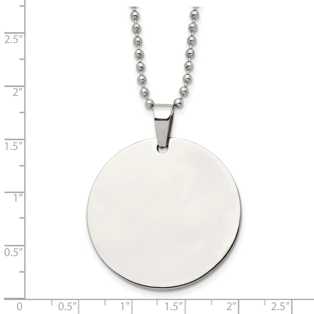 A polished silver circular pendant hangs from a silver ball chain necklace, displayed against a measurement scale showing the pendant is approximately one inch in diameter.