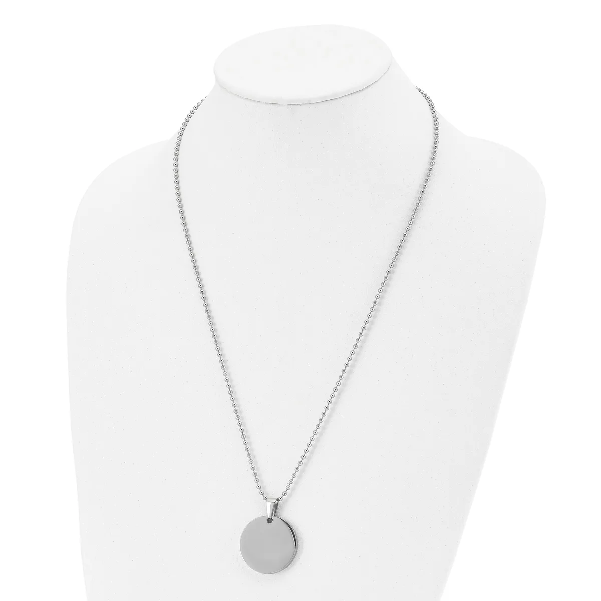 Silver-toned necklace with a thin chain and small circular pendant displayed on a white mannequin bust.
