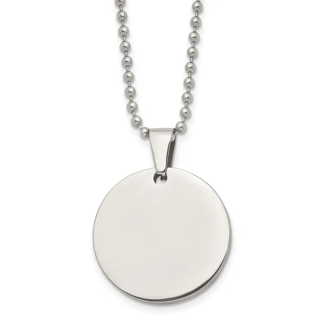 A polished stainless steel circular pendant hangs from a matching ball chain necklace.