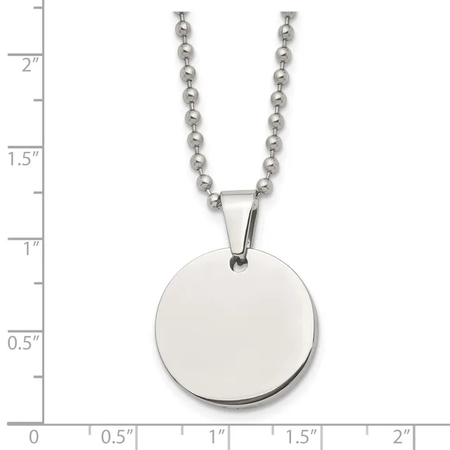 A stainless steel ball chain necklace with a large polished circular pendant, shown against a ruler measuring approximately 2 inches in length.