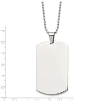 A stainless steel dog tag pendant with rounded corners hangs from a ball chain, shown against a measurement scale indicating its size is approximately 2.5 inches tall and 1.5 inches wide.